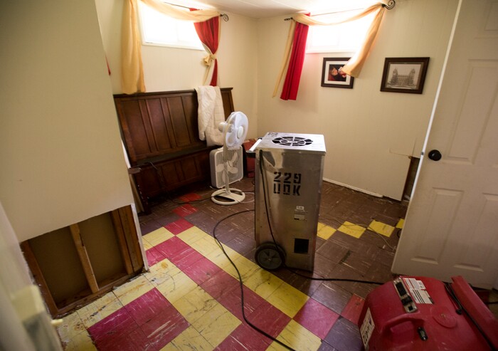 (Rick Egan  |  The Salt Lake Tribune)  Fans dry the basement of the Holt house now that the carpet and everything has been removed from the basement. Nearly everything that was in the basement needs to be thrown away, after sewage water flooded the basement of her home on 2100 South. Tuesday, August 1, 2017.