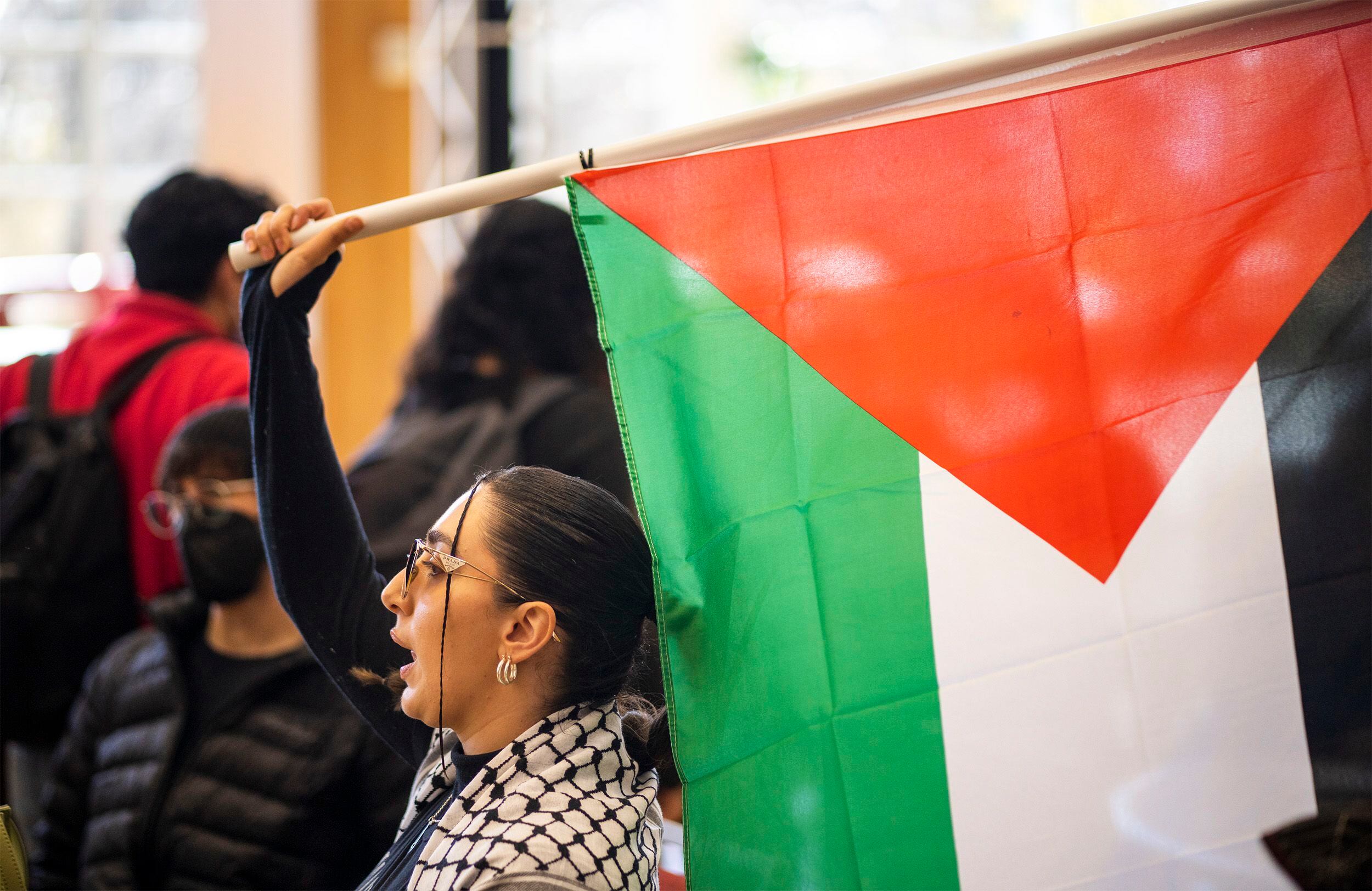 (Rick Egan | The Salt Lake Tribune) Muna Omar waves a flag a supporters of Mecha protest on the University of Utah Campus, on Wednesday, Nov. 15, 2023.
