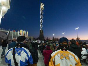 (Francisco Kjolseth | The Salt Lake Tribune) People gather near the Olympic cauldron before it is lit up on the 20-year anniversary of the Salt Lake 2002 Olympic Opening Ceremony at Rice-Eccles Stadium on Feb. 8, 2022. U.S. Olympic officials say they support Salt Lake's bid to host another games despite having some concerns about the state's new transgender sports law.