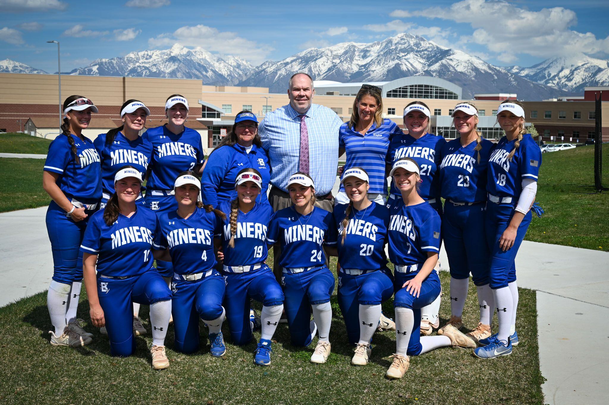 (Jordan School District) Bryan Veazie, center, postes for a photo with the Bingham High softball team. He is the district's Title IX athletic coordinator, appointed as a result of the girls' football lawsuit settlement.