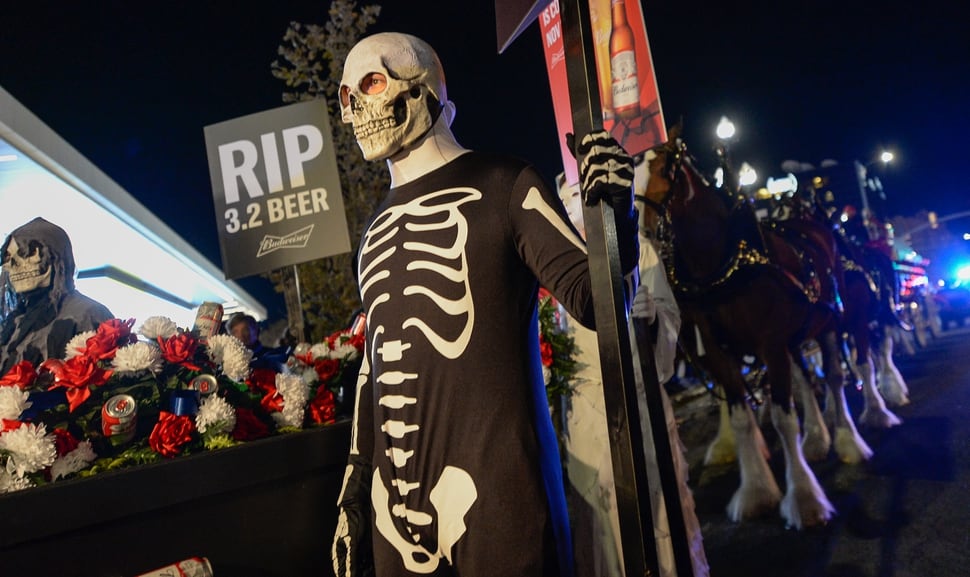 (Francisco Kjolseth | The Salt Lake Tribune) Budweiser’s iconic Clydesdales make a special trip to Utah to celebrate the changing beer laws in the state, joined by a “ghoulish group of pallbearers,” on Wed. Oct. 30, 2019, for a funeral procession for Utah’s last remaining 3.2 percent beer, on their way to Bar X, Beer Bar and Johnny’s on 200 South in Salt Lake City, as the state prepares to start selling 5 percent alcohol-by-volume in grocery and convenience stores starting Friday.