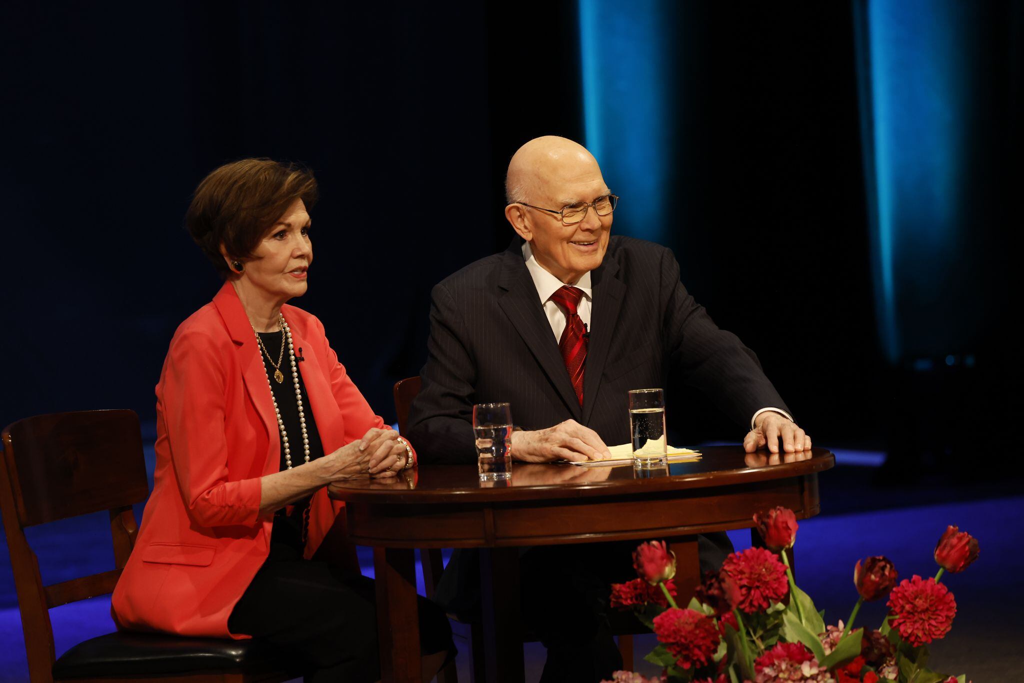 (The Church of Jesus Christ of Latter-day Saints)
President Dallin H. Oaks of the First Presidency of The Church of Jesus Christ of Latter-day Saints and wife Kristen speak to young adults at a worldwide devotional broadcast in May 2023. The couple urged young adults to stop delaying marriage and parenthood.