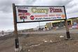 (Kolbie Peterson  |  The Salt Lake Tribune) A weathered sign leads travelers to Curry Pizza in Bicknell, west of Capitol Reef National Park in south-central Utah.
