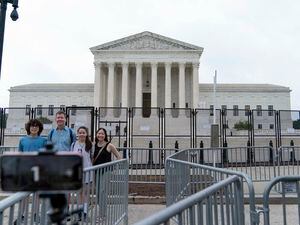(Jose Luis Magana | AP Photo) A family takes a selfie outside of the U.S. Supreme Court on Capitol Hill in Washington, Thursday, June 23, 2022.
