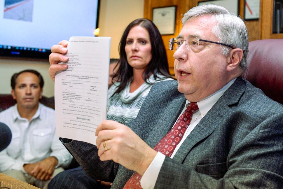Leah Hogsten | The Salt Lake Tribune Brenda Mayes, center, and her fiance Terry Martinez, left, joined attorney Robert Sykes, right, during a press conference announcing the lawsuit they filed, Tuesday, May 7, 2019 against the Davis School District, accusing a bus driver of racial discrimination against her son.