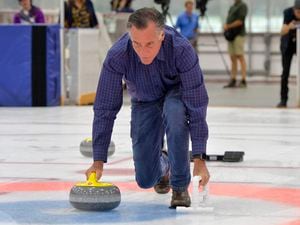 (Chris Samuels | The Salt Lake Tribune) Sen. Mitt Romney tries his hand at curling during a visit to the Utah Olympic Oval in Kearns, Friday, May 27, 2022.