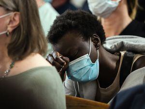 (Gabriela Bhaskar | The New York Times)

A worshiper wipes away tears while praying at Macedonia Baptist Church in Buffalo, N.Y., on Sunday, May 15, 2022, for the victims of the mass shooting at Tops supermarket. A day after one of the deadliest racist massacres in recent American history, law enforcement officials in New York descended on the home of the accused gunman and probed disturbing hints into his behavior, as Gov. Kathy Hochul promised action on hate speech that she said spreads "like a virus."