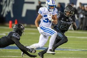 (Rick Egan  |  The Salt Lake Tribune)       Brigham Young Cougars running back Sione Finau (35) runs the ball for the Cougars, in football action between Brigham Young Cougars and Utah State Aggies in Logan, Saturday, Nov. 2, 2019.