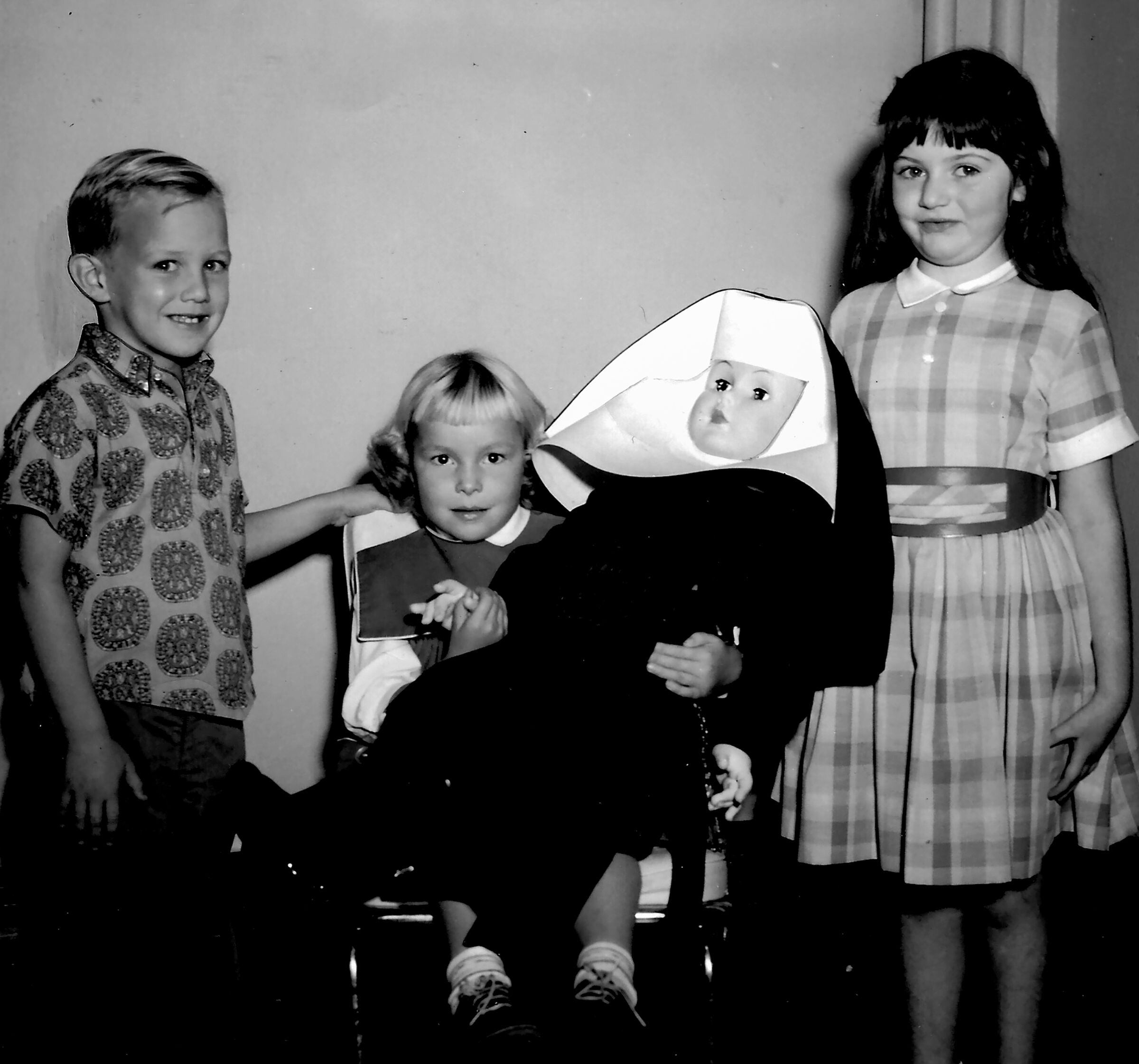 (Roman Catholic Diocese of Salt Lake City archives) Parochial schools were essential to encouraging Catholic schoolchildren to devote their lives to the church. Here three children at St. Ann School in the early 1960s hold a doll wearing the habit of their teachers, the Sisters of Charity of the Incarnate Word.
