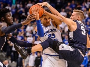 (Trent Nelson | The Salt Lake Tribune)  Brigham Young Cougars forward Yoeli Childs (23) defended by Utah State Aggies center Neemias Queta (23) and Utah State Aggies guard Sam Merrill (5) as BYU hosts Utah State, NCAA basketball in Provo on Wednesday Dec. 5, 2018.
