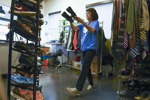 (Leah Hogsten  | Tribune file photo) "We could definitely use some volunteers," said Kathy Wagner, on July 17, 2019, as she was sorting clothing donations, racking shoes, sorting food and doing laundry as a volunteer for Volunteers of America.