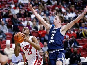 (Steve Marcus | Las Vegas Sun via AP) UNLV guard Luis Rodriguez (15) reacts after a foul by Utah State guard Sean Bairstow (2) during the first half of an NCAA college basketball game Wednesday, March 1, 2023, in Las Vegas.