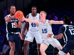 (Tim Aylen | Bahamas Visual Services via AP) Butler's Manny Bates, left, passes the ball as BYU's Richie Saunders reaches for it during an NCAA college basketball game in the Battle 4 Atlantis at Paradise Island, Bahamas, Thursday, Nov. 24, 2022.
