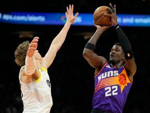 Phoenix Suns center Deandre Ayton (22) shoots over Utah Jazz forward Lauri Markkanen during the second half of an NBA basketball game Saturday, Nov. 26, 2022, in Phoenix. The Suns won 113-112. (AP Photo/Rick Scuteri)