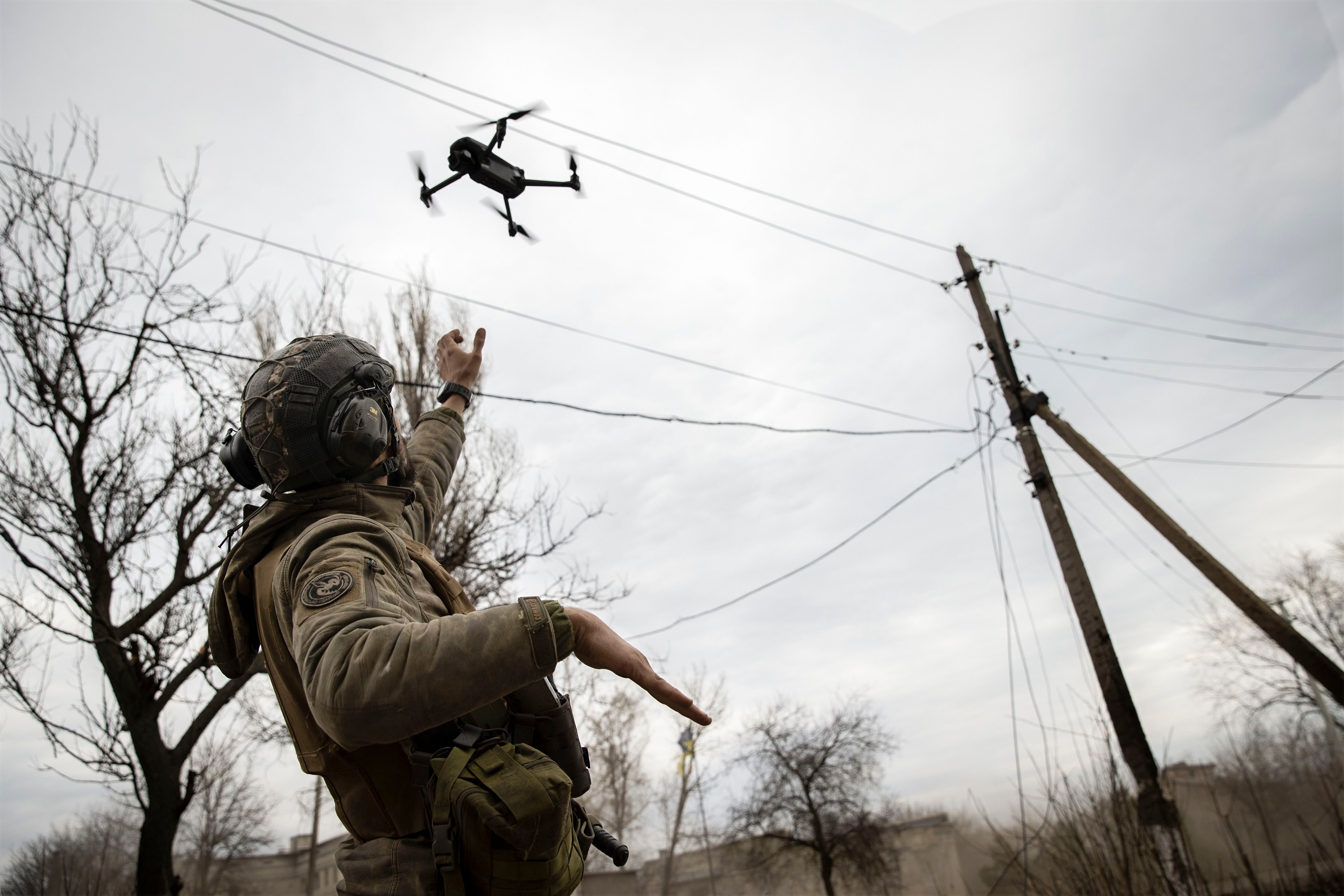 (Tyler Hicks | The New York Times) A Ukrainian soldier operates a DJI drone on the front line of the war, in the Donetsk region of eastern Ukraine on March 15, 2023. U.S. authorities consider Chinese drone maker DJI a security threat; Congress is weighing legislation to ban it, prompting a lobbying campaign from the company, which dominates the commercial and consumer drone markets.