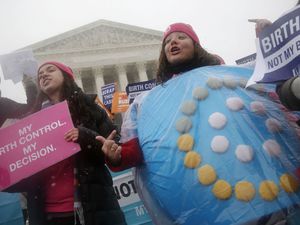 FILE - In this March 25, 2015 file photo, Margot Riphagen of New Orleans, La., wears a birth control pills costume during a protest in front of the U.S. Supreme Court in Washington. (AP Photo/Charles Dharapak, File)
