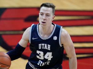 (John Locher | AP) Utah State's Justin Bean (34) plays against UNLV in an NCAA college basketball game Wednesday, Jan. 27, 2021, in Las Vegas. This season, Bean ranks in the top 10 nationally in both scoring and rebounding.