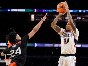 Connecticut guard Jordan Hawkins shoots over Miami guard Nijel Pack during the second half of a Final Four college basketball game in the NCAA Tournament on Saturday, April 1, 2023, in Houston. (AP Photo/Brynn Anderson)