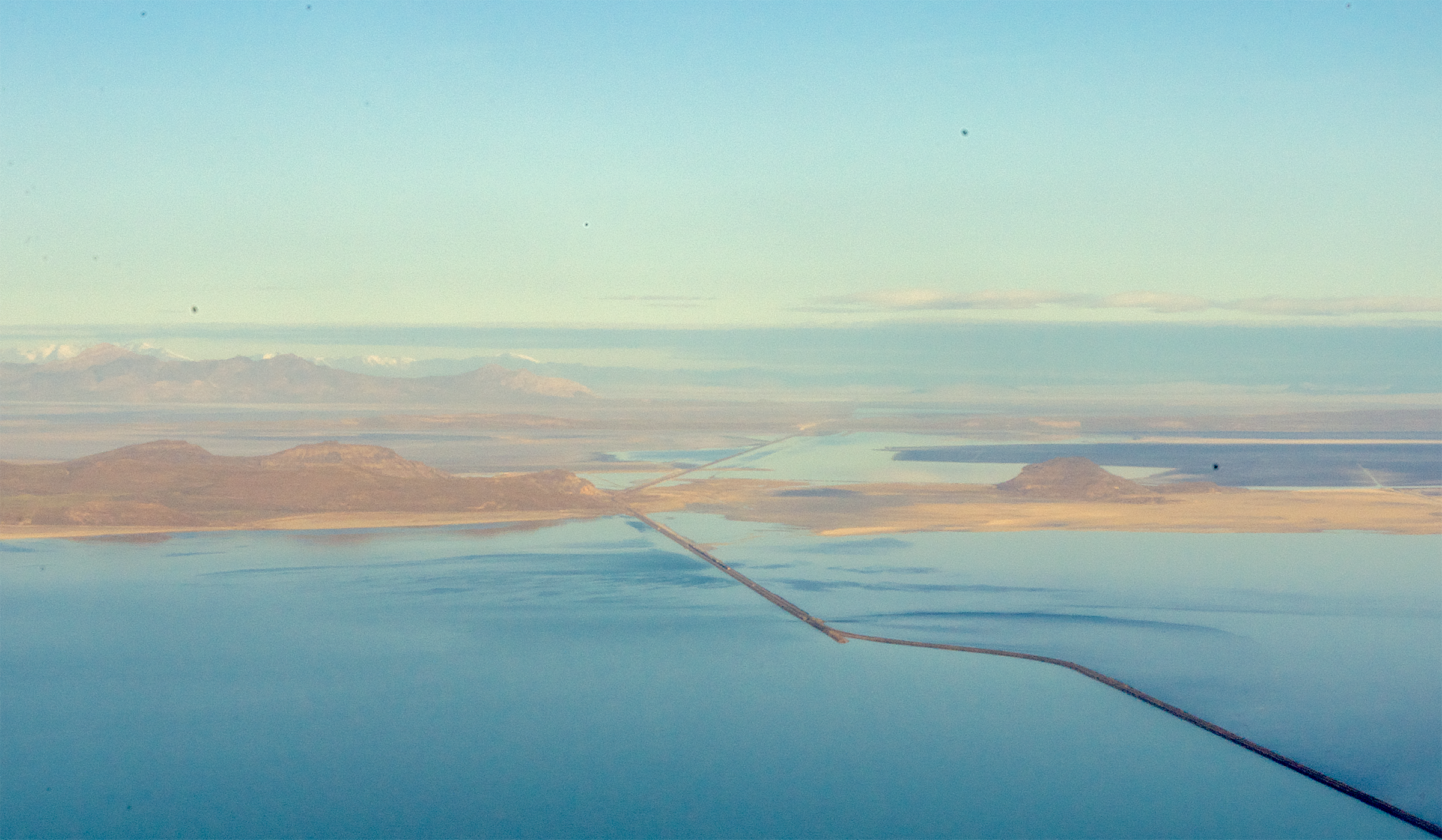 (Megan Banta | The Salt Lake Tribune) The railroad causeway and berm used to regulate flow to the north arm of the Great Salt Lake are visible during a flyover of the lake with EcoFlight on Tuesday, April 9, 2024.