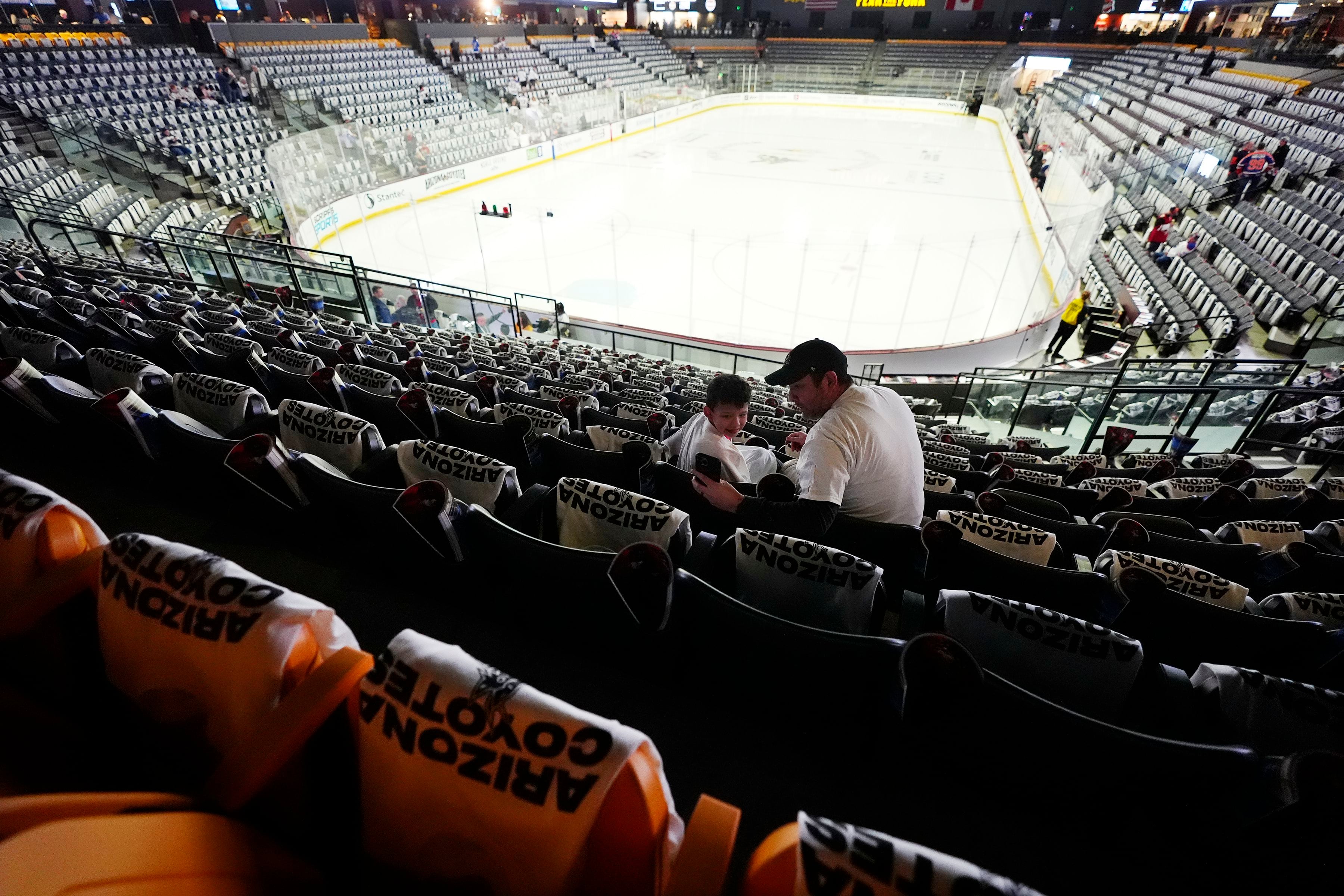 (Ross D. Franklin | AP) Arizona Coyotes fans start to find their seats at Mullett Arena prior to the team's game.