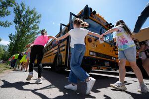 (Francisco Kjolseth | The Salt Lake Tribune) Individual classrooms hold hands as they exit school buses as students from Cedar Ridge Elementary participate in a reunification training drill, aimed to practice notifying parents of a child's location and condition in the event of an emergency, at the Cache County Event Center in Logan on Friday, May 27, 2022.